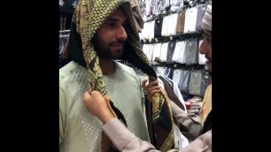 'A man from Yemen demonstrates how to wear a Yemeni head scarf in Medina'
