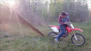 Fat kid does epic burnout on anthill with dirtbike