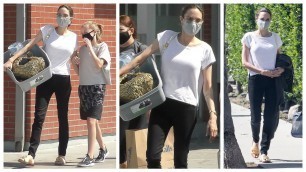 Angelina Jolie casual look in jeans and T-shirt while taking her daughter Vivienne to pet store