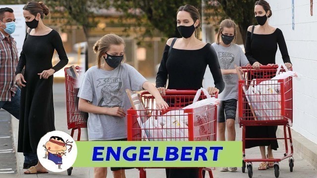 Angelina Jolie looks tired when appearing with her daughter Vivienne packing up school supplies ...