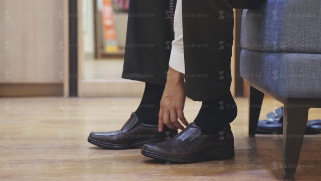 'Man puts on socks and brown new fashion shoes. Close up. slow motion. 3840x2160'